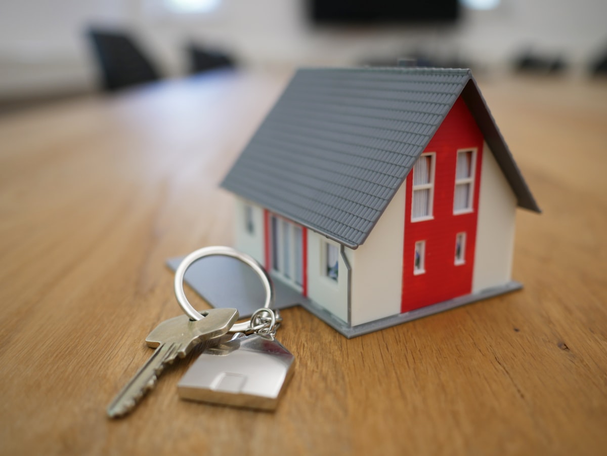House model with a set of keys symbolising property handover