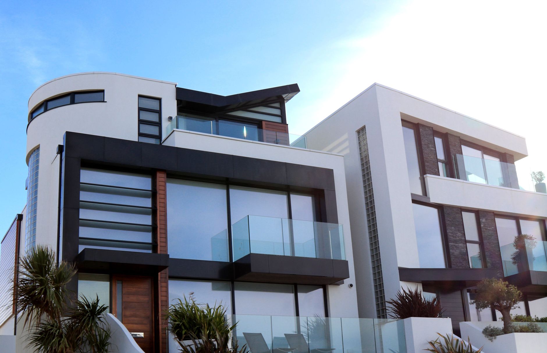 Modern residential building facade with glass-railed balconies